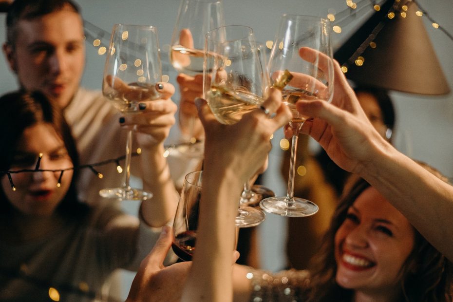 selective focus photography of several people cheering wine glasses