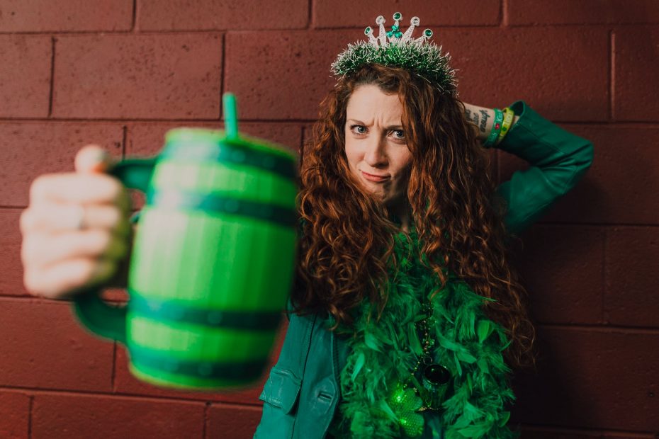 a woman holding a green mug